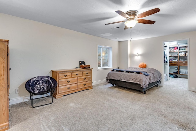 bedroom featuring baseboards, visible vents, a spacious closet, and carpet flooring