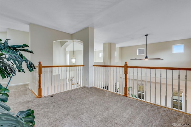 unfurnished room featuring ceiling fan, carpet, visible vents, and baseboards