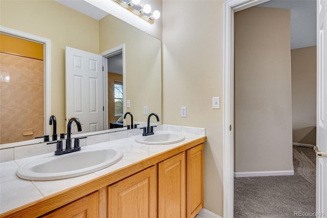 full bath featuring double vanity, a sink, and baseboards