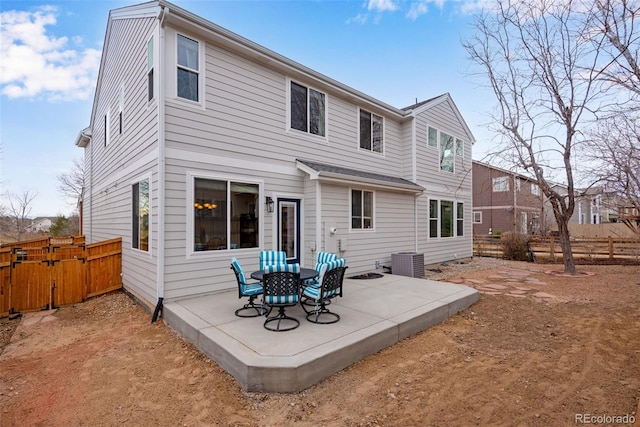 back of property with a patio area and fence