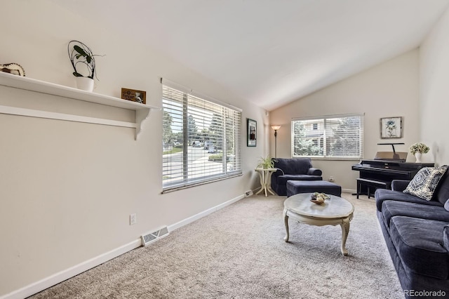 6212 S Ash Cir W, Centennial, CO 80121 - living area with vaulted ceiling, carpet floors, and healthy amount of natural light
