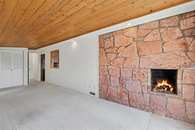 150 Apache Trl, Woodland Park, CO 80863 - unfurnished living room featuring wooden ceiling, a warm lit fireplace, and carpet