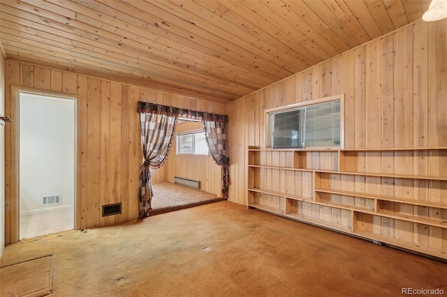 150 Apache Trl, Woodland Park, CO 80863 - carpeted empty room featuring wooden ceiling, baseboard heating, and wood walls