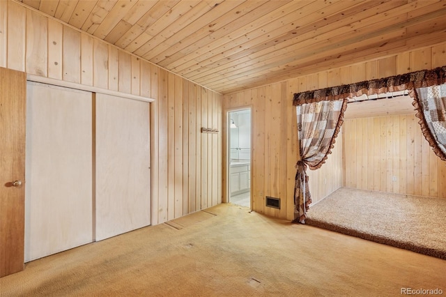 150 Apache Trl, Woodland Park, CO 80863 - unfurnished bedroom featuring carpet, wood ceiling, wooden walls, a closet, and ensuite bathroom