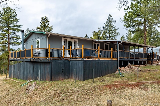 back of house with a deck and french doors