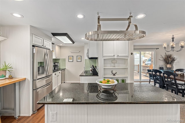 kitchen featuring light wood-type flooring, white cabinetry, stainless steel fridge with ice dispenser, dark stone countertops, and an inviting chandelier