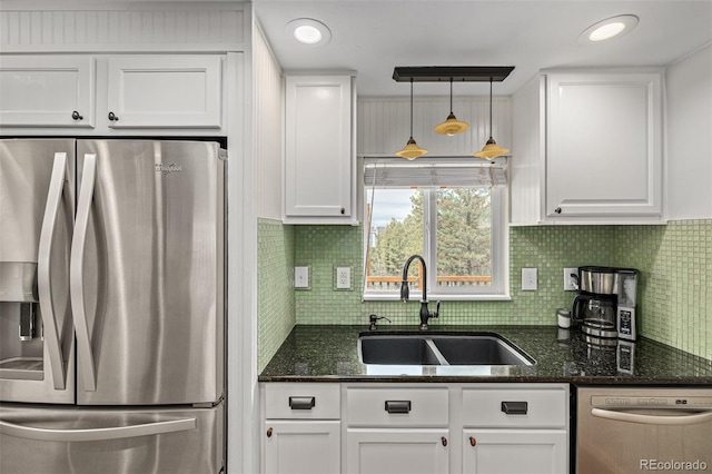 kitchen featuring sink, appliances with stainless steel finishes, and white cabinetry