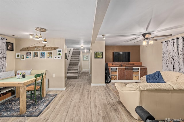 living room with wood-type flooring and ceiling fan