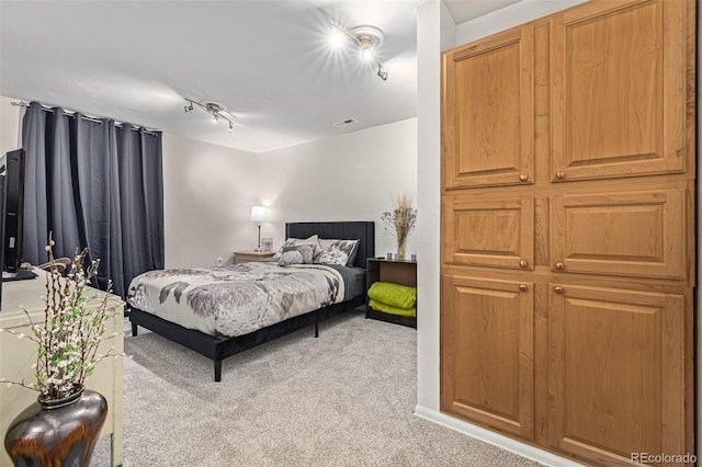 carpeted bedroom with track lighting