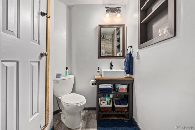 bathroom featuring sink, toilet, and hardwood / wood-style floors