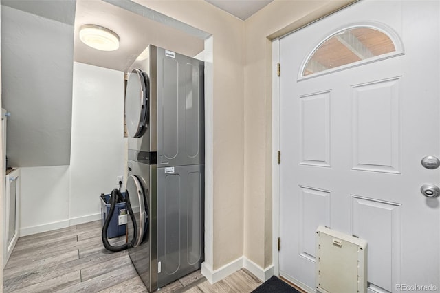 interior space featuring hardwood / wood-style flooring and stacked washer / drying machine