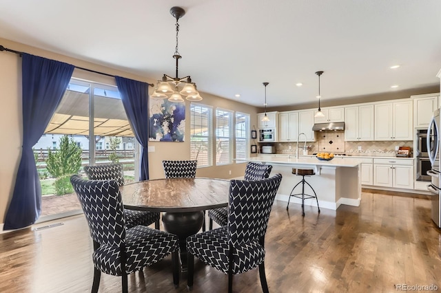 2165 Summerlin Ln, Longmont, CO 80503 - dining room with wood finished floors, recessed lighting, and a chandelier