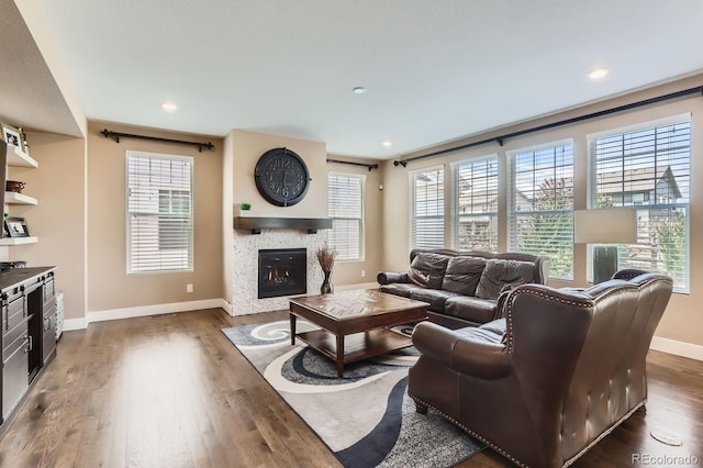 2165 Summerlin Ln, Longmont, CO 80503 - living room with baseboards, a lit fireplace, dark wood-style floors, and plenty of natural light