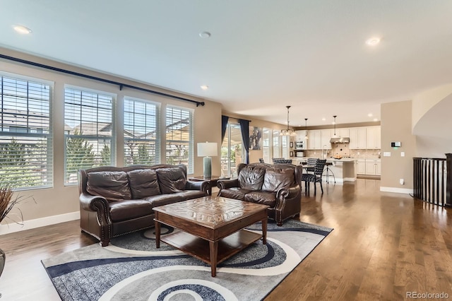 2165 Summerlin Ln, Longmont, CO 80503 - living area with plenty of natural light, baseboards, dark wood-type flooring, recessed lighting, and arched walkways