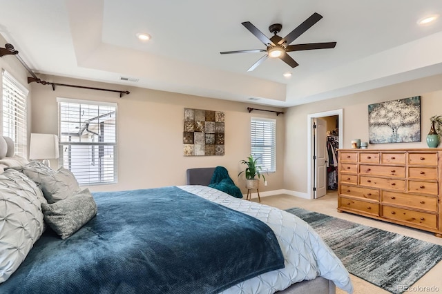 2165 Summerlin Ln, Longmont, CO 80503 - bedroom featuring a spacious closet, light carpet, recessed lighting, a raised ceiling, and baseboards