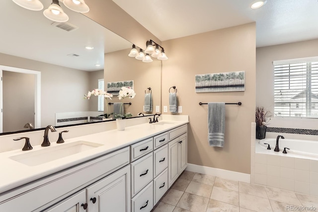 2165 Summerlin Ln, Longmont, CO 80503 - full bathroom featuring double vanity, a garden tub, baseboards, and recessed lighting