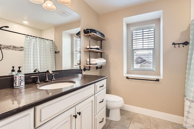 2165 Summerlin Ln, Longmont, CO 80503 - full bathroom featuring healthy amount of natural light, vanity, baseboards, and toilet