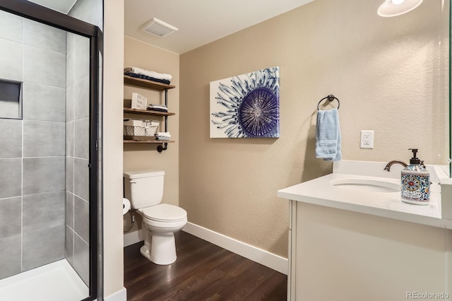 2165 Summerlin Ln, Longmont, CO 80503 - full bath with wood finished floors, a shower stall, toilet, vanity, and baseboards