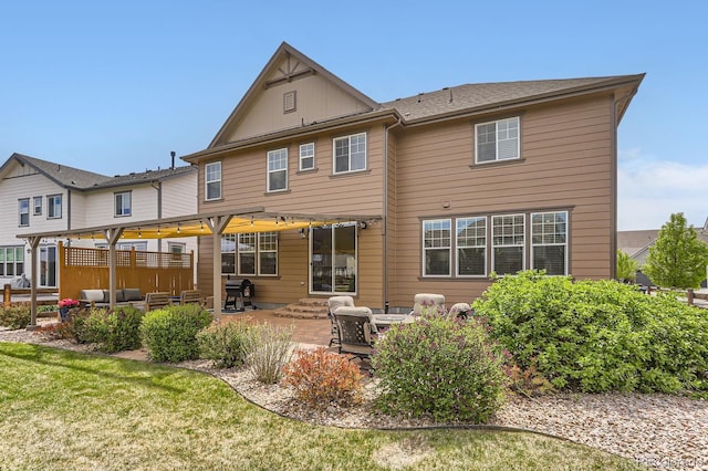 2165 Summerlin Ln, Longmont, CO 80503 - back of property with a patio area, an outdoor hangout area, and board and batten siding
