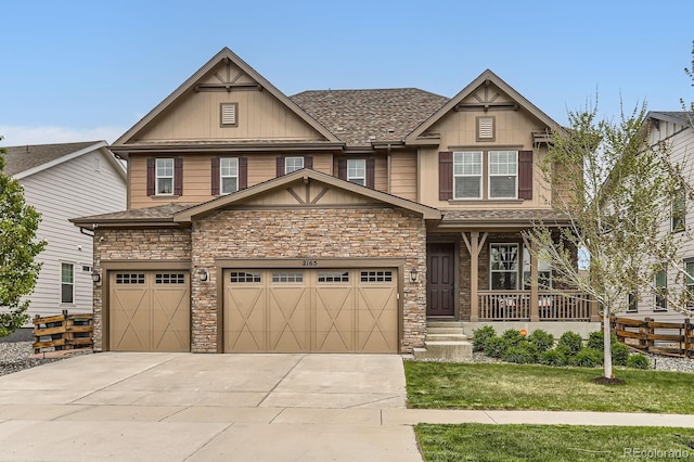2165 Summerlin Ln, Longmont, CO 80503 - craftsman house with concrete driveway, stone siding, a porch, board and batten siding, and a front lawn