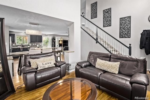 10076 Helena St, Commerce City, CO 80022 - living room featuring wood finished floors and stairs