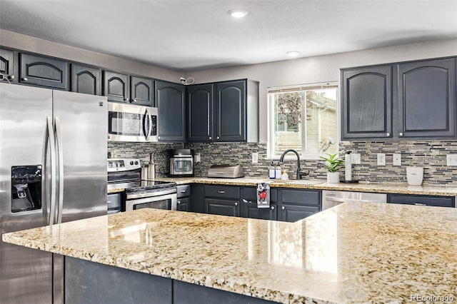 10076 Helena St, Commerce City, CO 80022 - kitchen with appliances with stainless steel finishes, light stone countertops, decorative backsplash, recessed lighting, and gray cabinetry