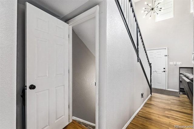 10076 Helena St, Commerce City, CO 80022 - staircase featuring a chandelier and wood finished floors