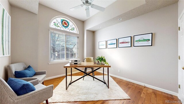 2266 S Kenton St, Aurora, CO 80014 - home office with a ceiling fan, light wood-style flooring, and baseboards