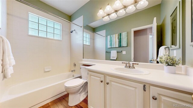 2266 S Kenton St, Aurora, CO 80014 - full bath with wood finished floors, tub / shower combination, vanity, and toilet