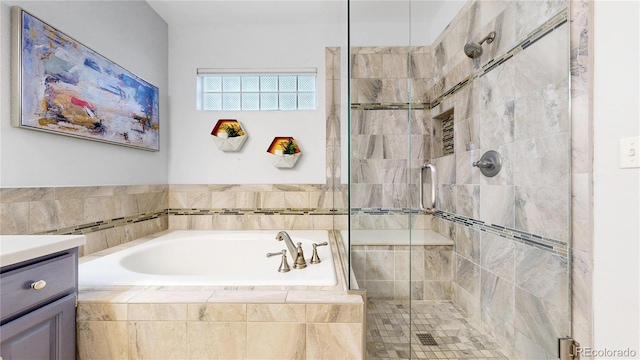 2266 S Kenton St, Aurora, CO 80014 - bathroom featuring a stall shower, a garden tub, and vanity