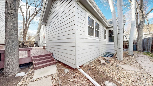 2266 S Kenton St, Aurora, CO 80014 - view of property exterior with fence, a deck, and central AC unit
