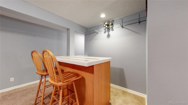 2266 S Kenton St, Aurora, CO 80014 - bar with a bar, baseboards, and light colored carpet