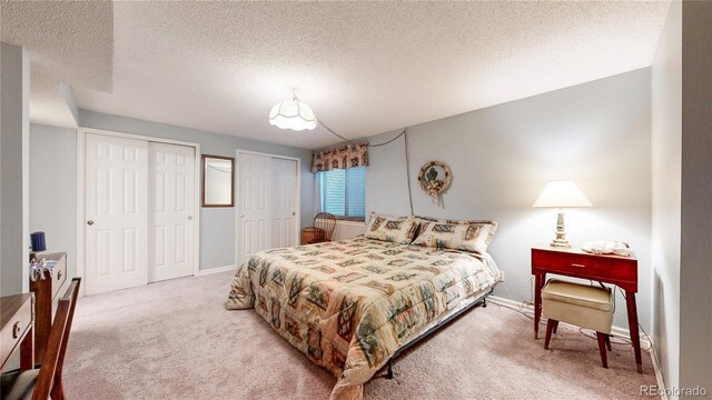 2266 S Kenton St, Aurora, CO 80014 - bedroom featuring multiple closets, carpet, a textured ceiling, and baseboards