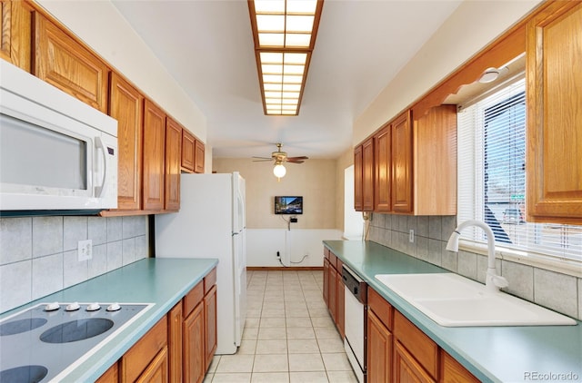 kitchen featuring sink, white appliances, light tile patterned floors, ceiling fan, and decorative backsplash