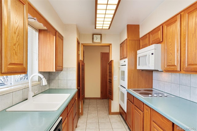 kitchen featuring white appliances, sink, decorative backsplash, and light tile patterned floors