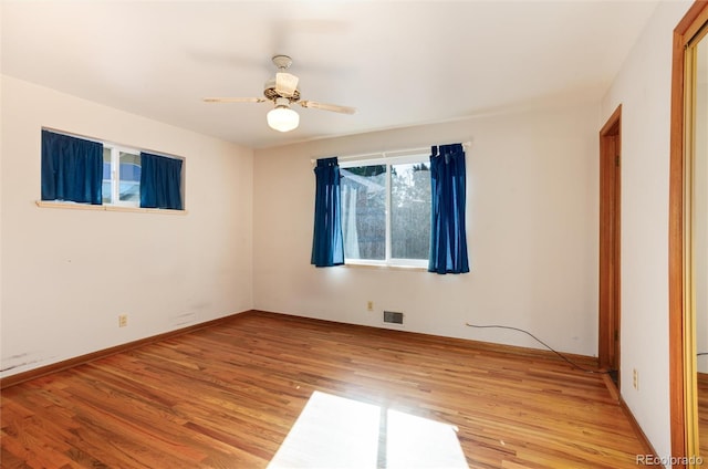 spare room with ceiling fan and light wood-type flooring