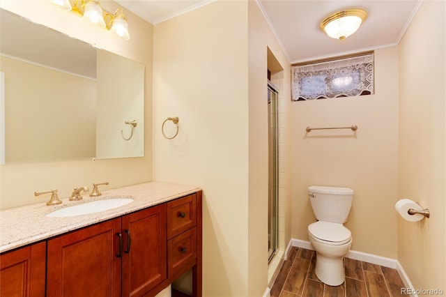 bathroom with an enclosed shower, vanity, crown molding, and toilet