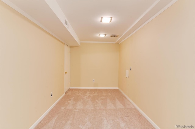 carpeted empty room featuring crown molding