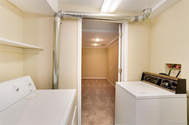 laundry area with light carpet, crown molding, and washing machine and dryer