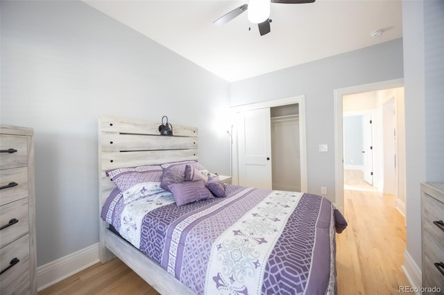 bedroom with a ceiling fan, a closet, baseboards, and wood finished floors