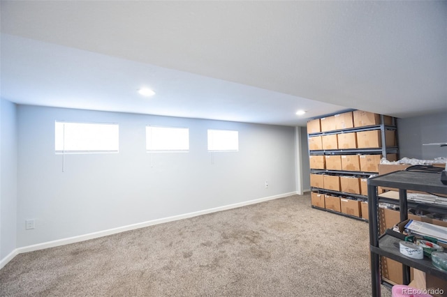 basement featuring recessed lighting, plenty of natural light, carpet flooring, and baseboards