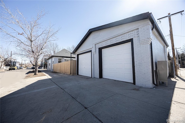 detached garage featuring fence