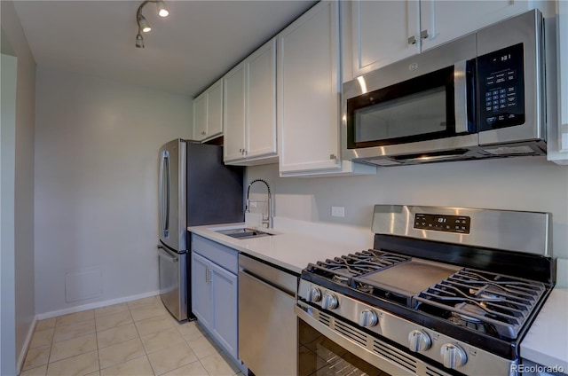 2100 N Franklin St Unit 8, Denver, CO 80205 - kitchen featuring stainless steel appliances, a sink, white cabinetry, light countertops, and baseboards