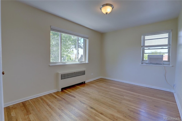 2100 N Franklin St Unit 8, Denver, CO 80205 - unfurnished room with radiator, light wood-type flooring, baseboards, and cooling unit
