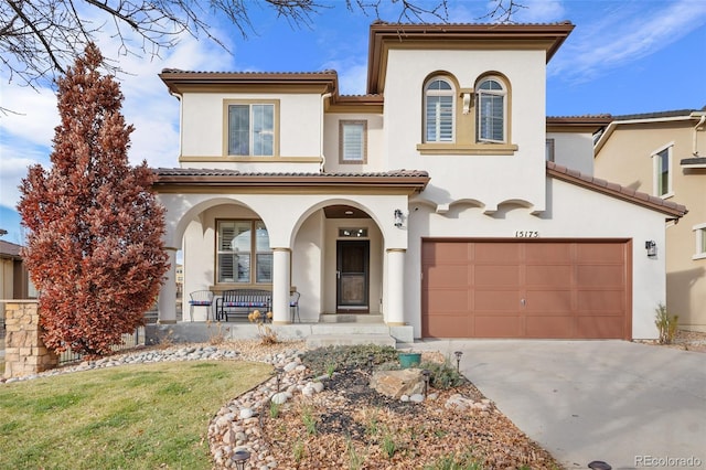 mediterranean / spanish house featuring a porch and a garage