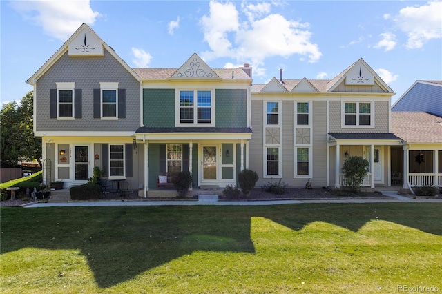 view of front of property with covered porch and a front lawn