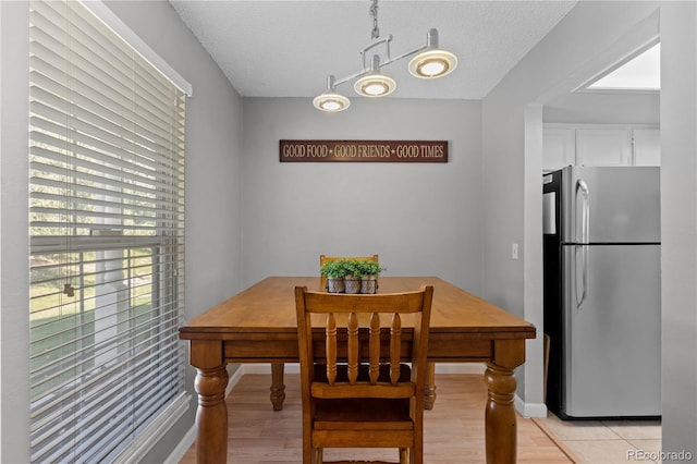 dining space featuring a textured ceiling