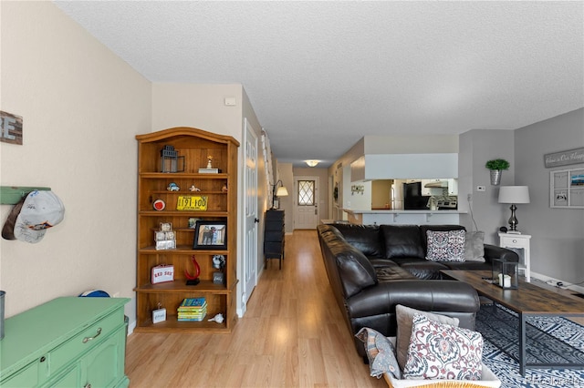 living room featuring light hardwood / wood-style floors and a textured ceiling