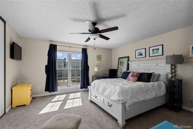 bedroom with a textured ceiling, ceiling fan, and carpet