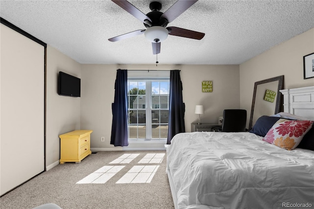 bedroom with light colored carpet, a textured ceiling, and ceiling fan